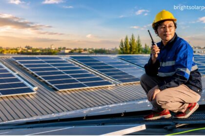 Technician inspecting rooftop solar panels with a flat plate solar collector system for efficient renewable energy generation.