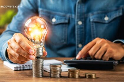 Solar savings concept with a glowing light bulb, coins, and energy-efficient planning.