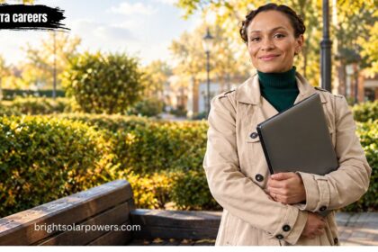 Sierra careers professional woman holding laptop in park.